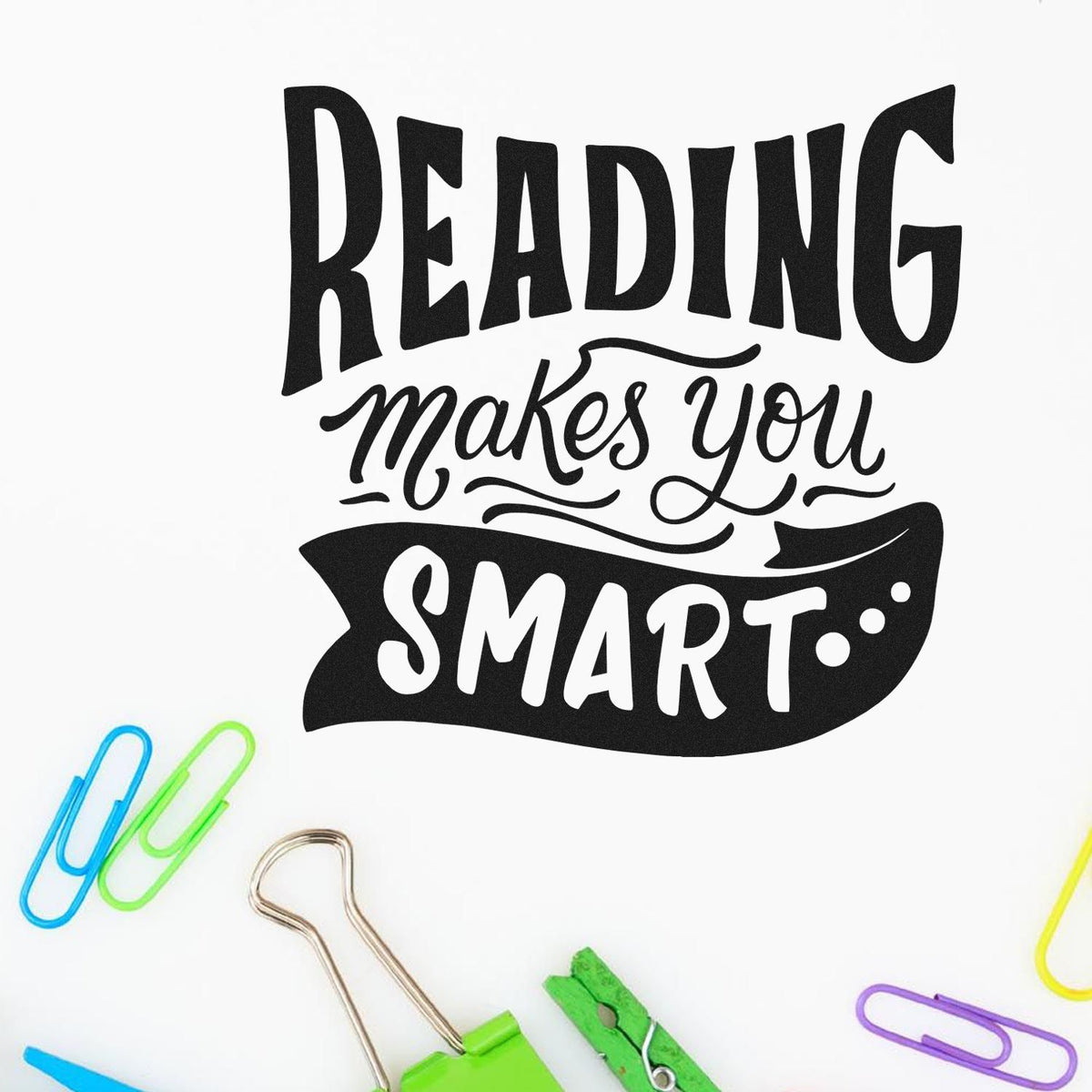 Black Reading makes you smart stamp design on white, with colorful paper clips around it.