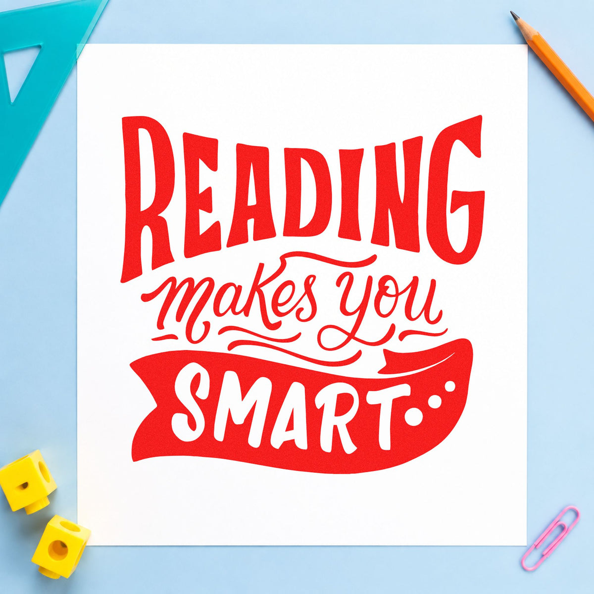 Reading Makes You Smart rubber stamp shown in red ink, stamped for projects such as summer read notes.