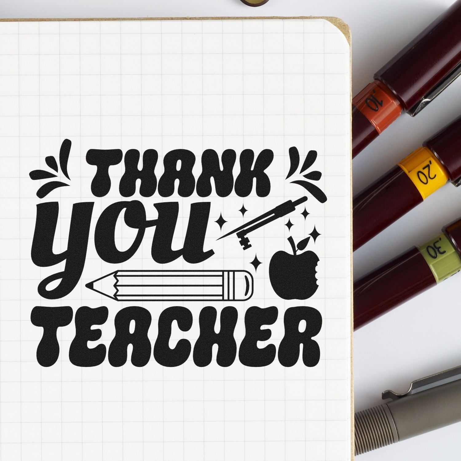 Black THANK YOU TEACHER stamp design on grid notebook, with pencil, apple, sparkles, and burgundy, yellow, green seal markers.