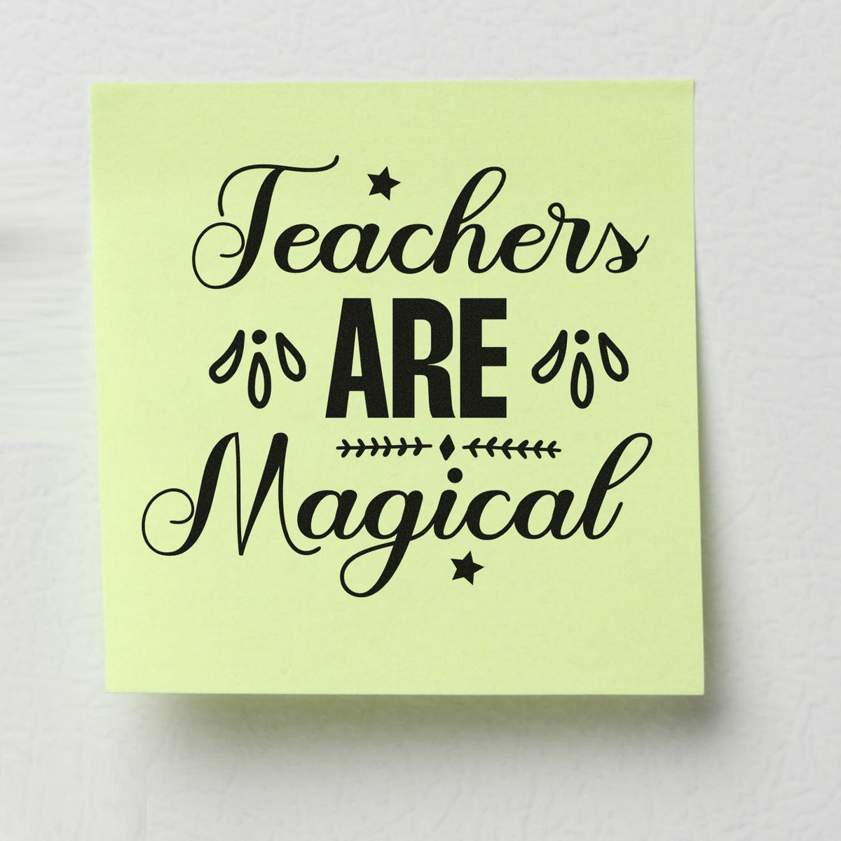 Pale yellow stamp seal reading Teachers Are Magical in black script and bold text with stars and leaf accents.