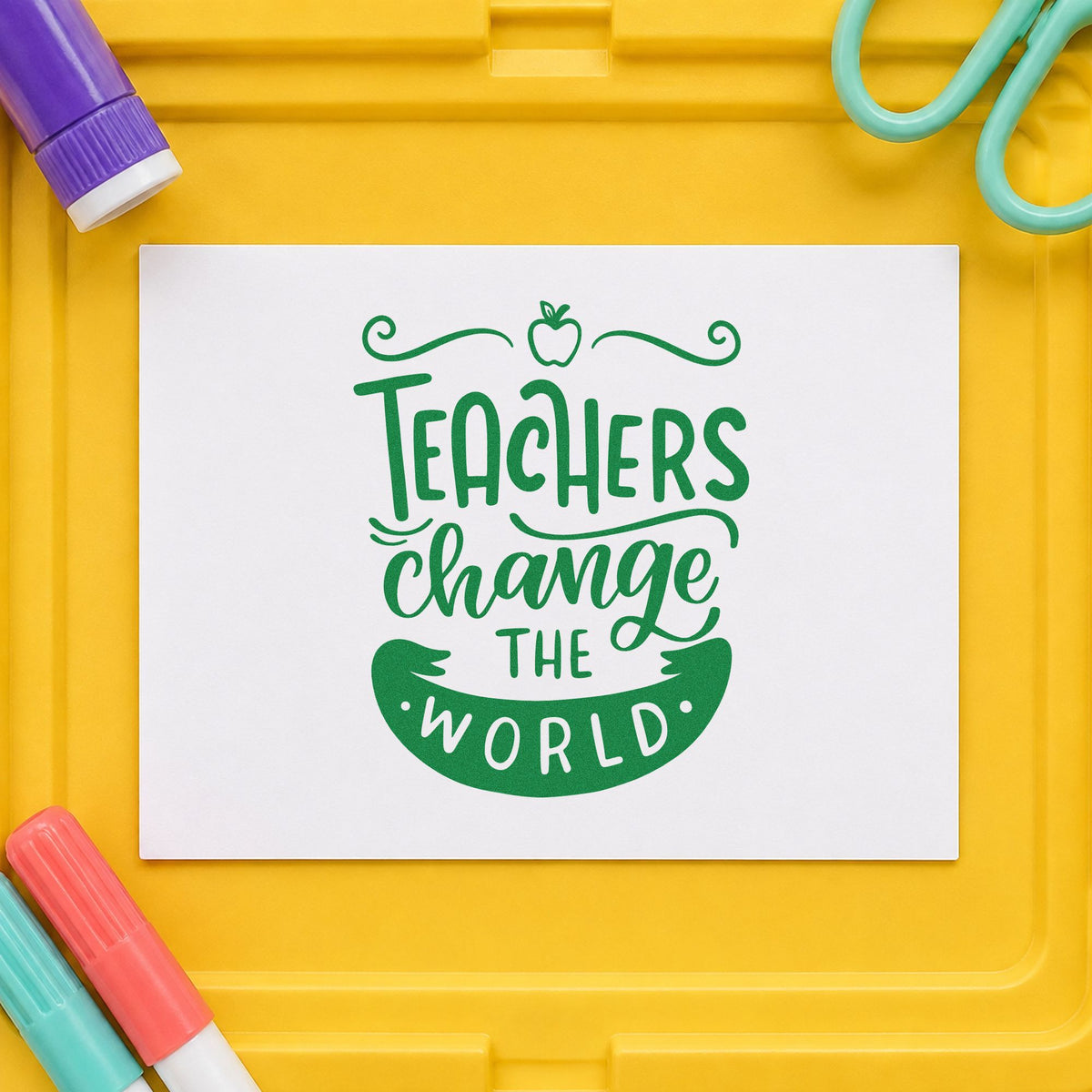Teachers Change The World Apple craft stamp imprint in green ink on a handmade project, one idea being manifesto pages.