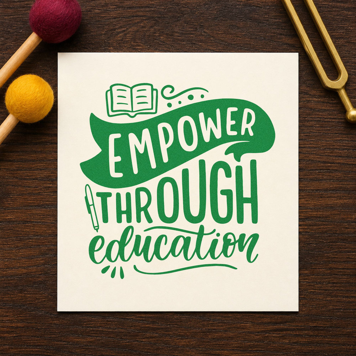 Empower Through Education craft stamp imprint in green ink on a handmade project, one idea being application pages.