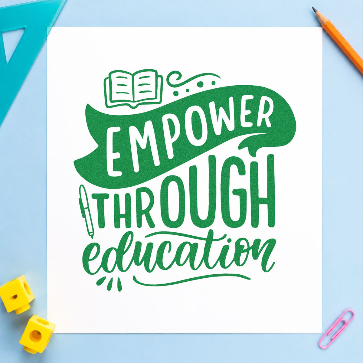 Empower Through Education craft stamp imprint in green ink on a handmade project, one idea being framed fund board.