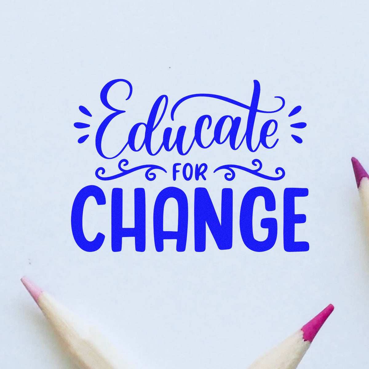 Blue Educate for Change stamp seal with decorative lettering and pink pencil tips on a white background.