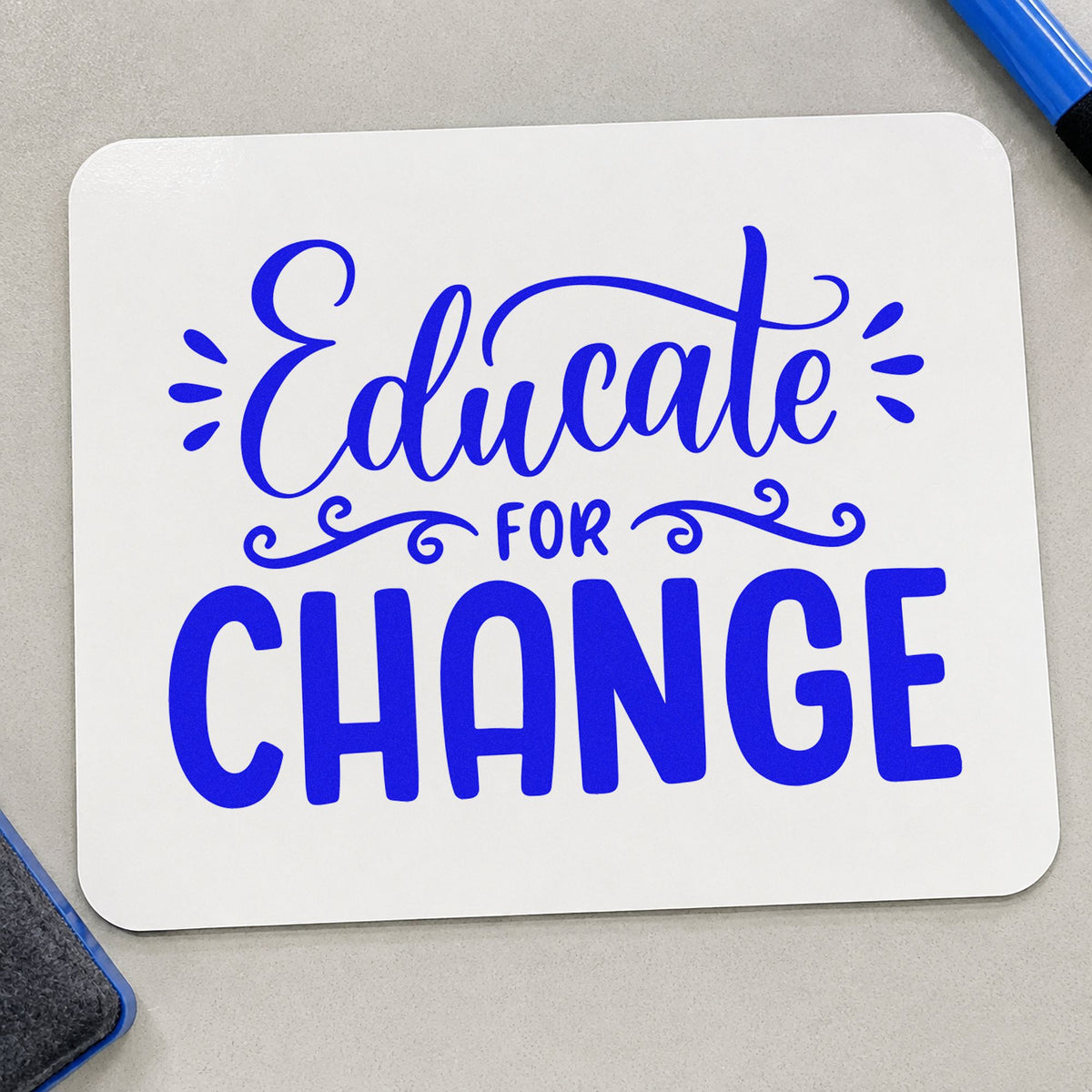 Educate For Change craft stamp imprinted in blue ink on paper, a design suited to reading pack seals.