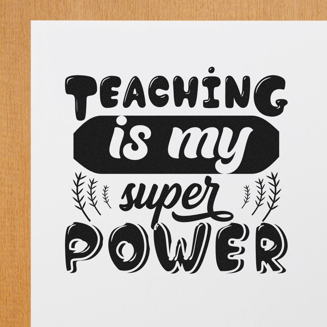 Black stamp-style teaching seal reading Teaching is my super power in bold decorative lettering on white paper.