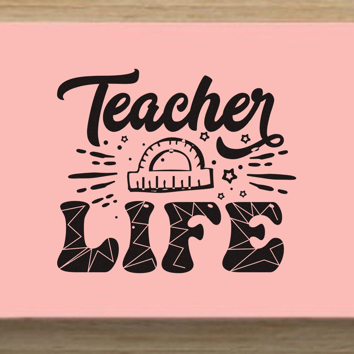 Pink teacher stamp and seal design with black script, ruler arch, stars, and geometric LIFE lettering.