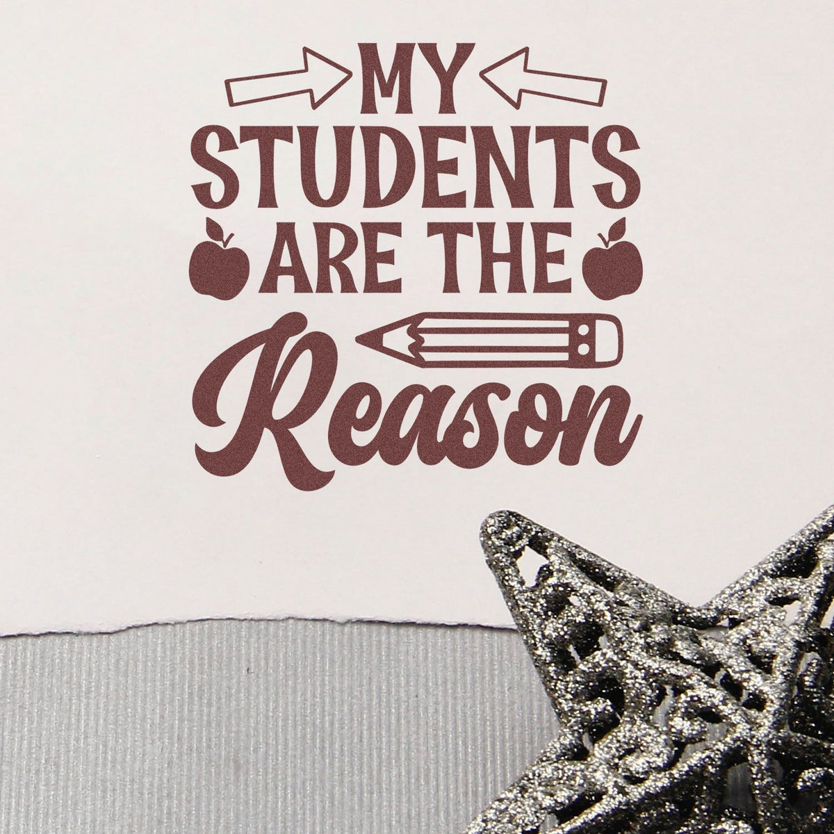 Maroon My students are the reason stamp with arrows, apples and pencil, plus a glittery silver star seal on white background.