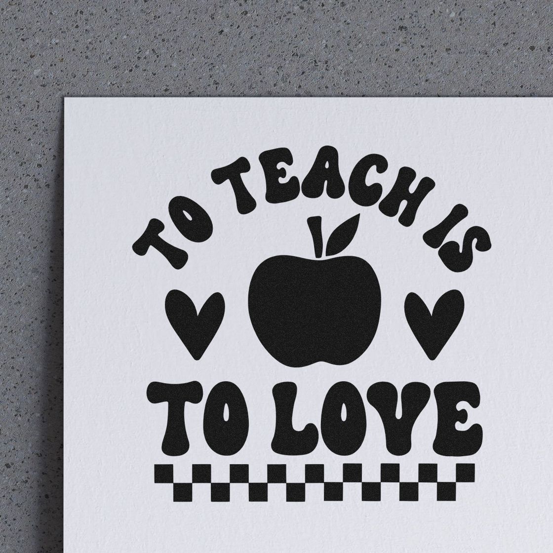 Black teacher stamp seal on white paper with To Teach Is To Love, apple, hearts, and checkerboard border.