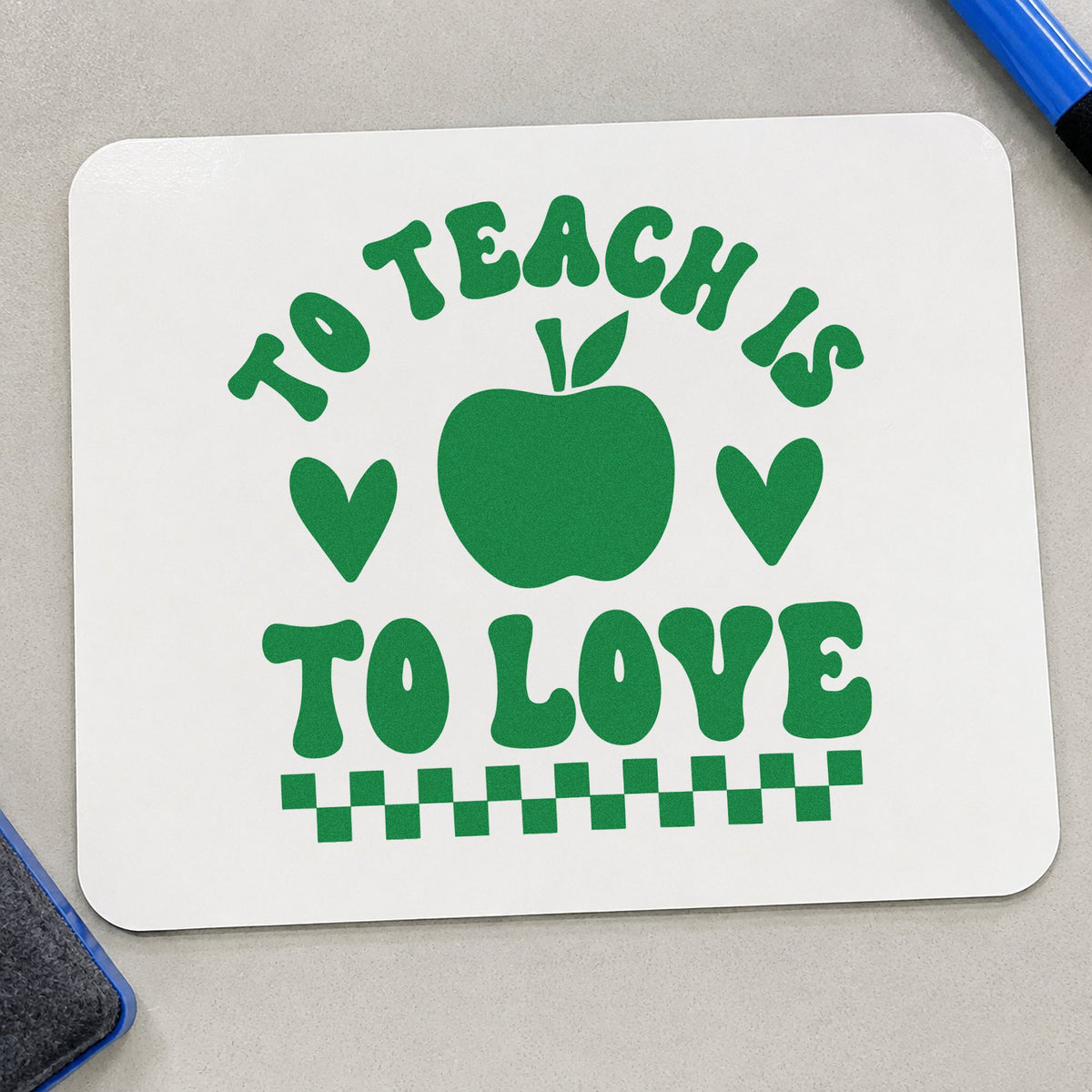 To Teach Is To Love craft stamp imprint in green ink on a handmade project, one idea being order slip pages.