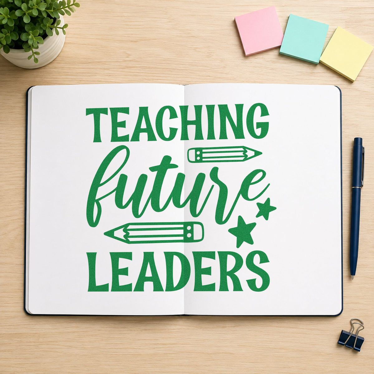 Teaching Future Leaders Pencils craft stamp imprint in green ink on a handmade project, one idea being manifesto pages.