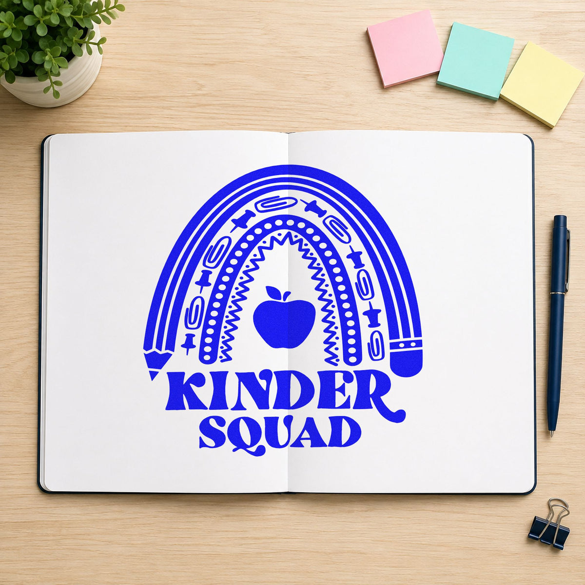 Kinder Squad Rainbow Apple craft stamp in blue ink on cardstock, an easy option for story rug panels.
