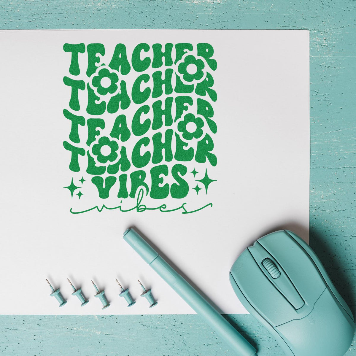 Mint green teacher vibes stamp and seal set with retro floral lettering, pen, and pins on white paper.