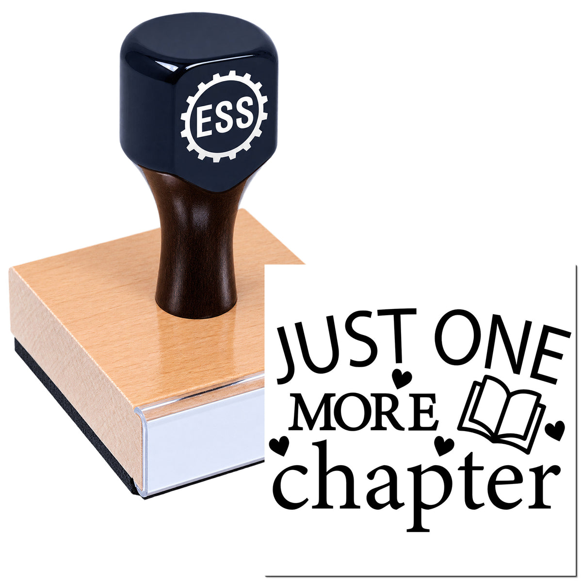 Black ESS rubber stamp seal on a light wood block, showing "Just One More Chapter" with book icon and hearts.