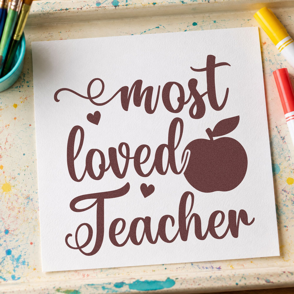 Most Loved Teacher Apple rubber stamp printed in brown ink, ready for gift pile labels and similar paper crafts.