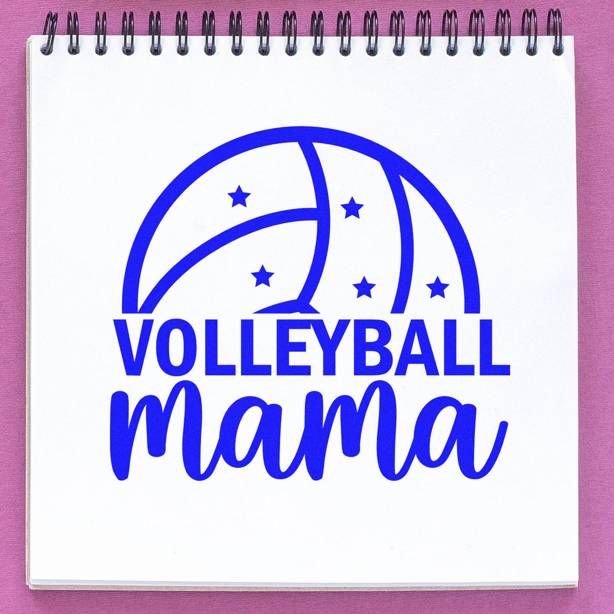 Blue volleyball mama stamp design with star accents on a white spiral notebook page, for seals and stamps, against a pink background.