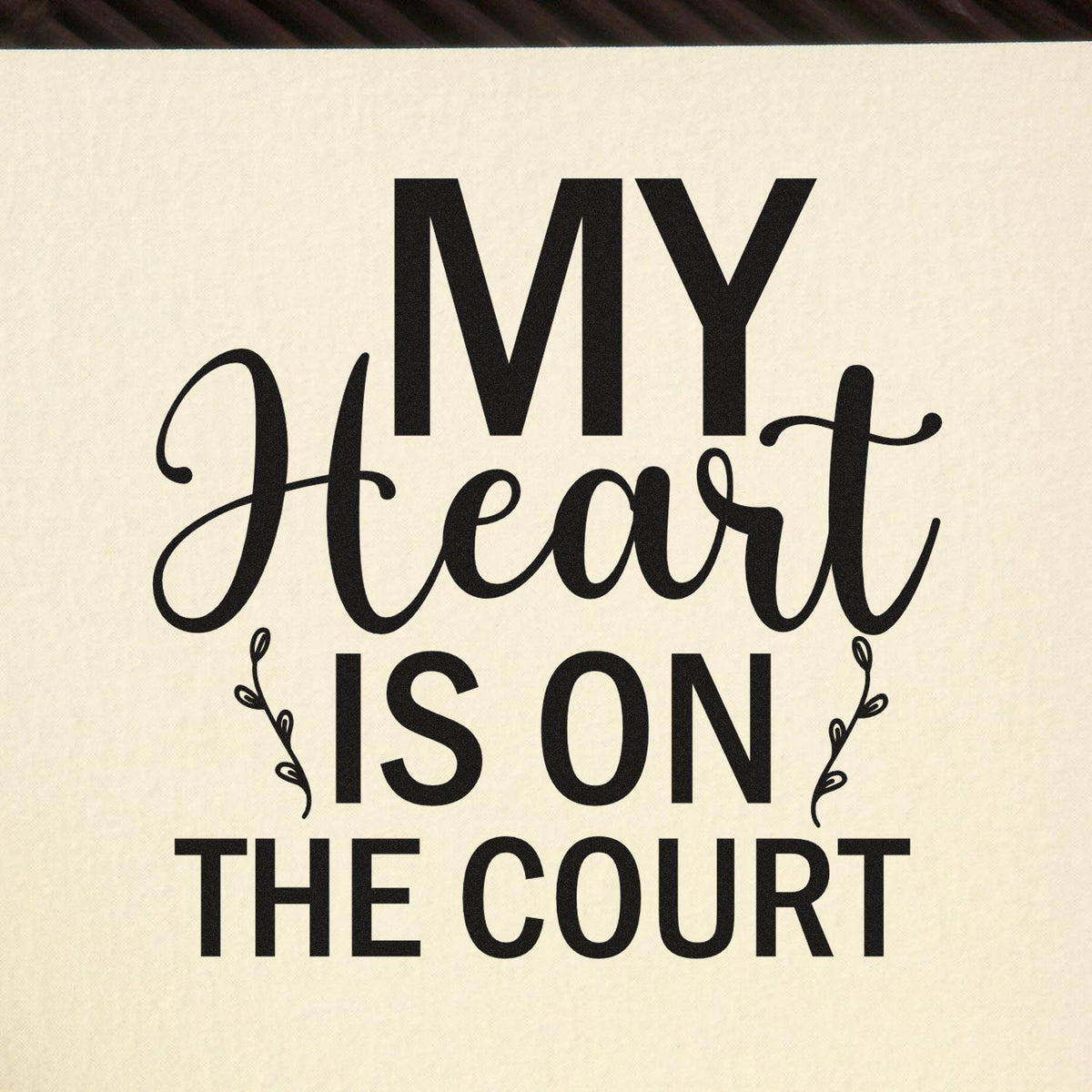 Black decorative stamp/seal with My Heart Is On The Court in bold and script black text on a cream background.