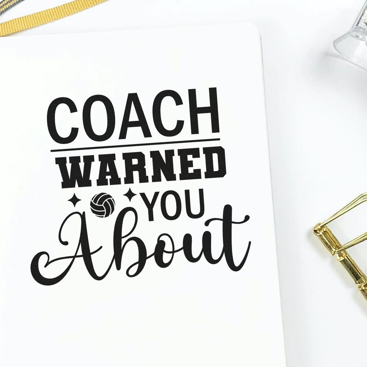 Custom stamp and seal design reading COACH WARNED YOU About with volleyball icon on white paper, accented by gold clips.