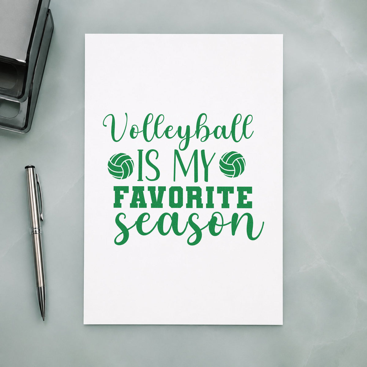 Volleyball Favorite Season craft stamp imprint in green ink on a handmade project, one idea being calendar grid pages.