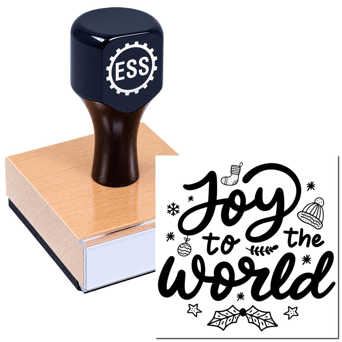Dark navy ESS stamp seal on a pink wooden block beside a black holiday "Joy to the World" design with stars and ornaments.