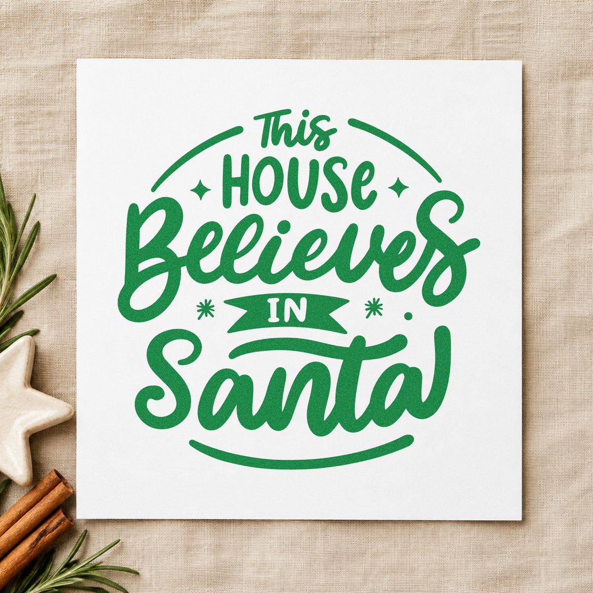 This House Believes In Santa craft stamp imprinted in green ink on paper, a design suited to sack cord seals.