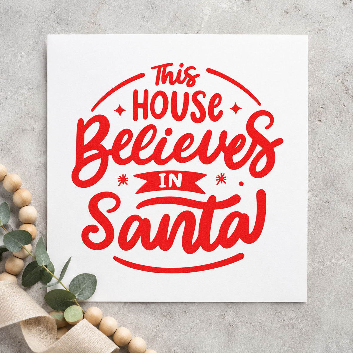 This House Believes In Santa rubber stamp shown in red ink, stamped for projects such as christmas eve notes.