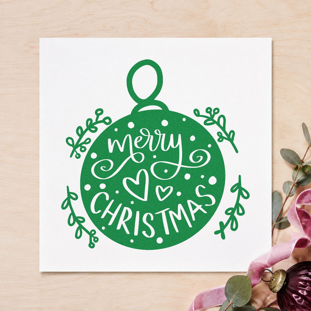 Merry Christmas Round Ornament craft stamp imprint in green ink on a handmade project, one idea being keepsake log pages.