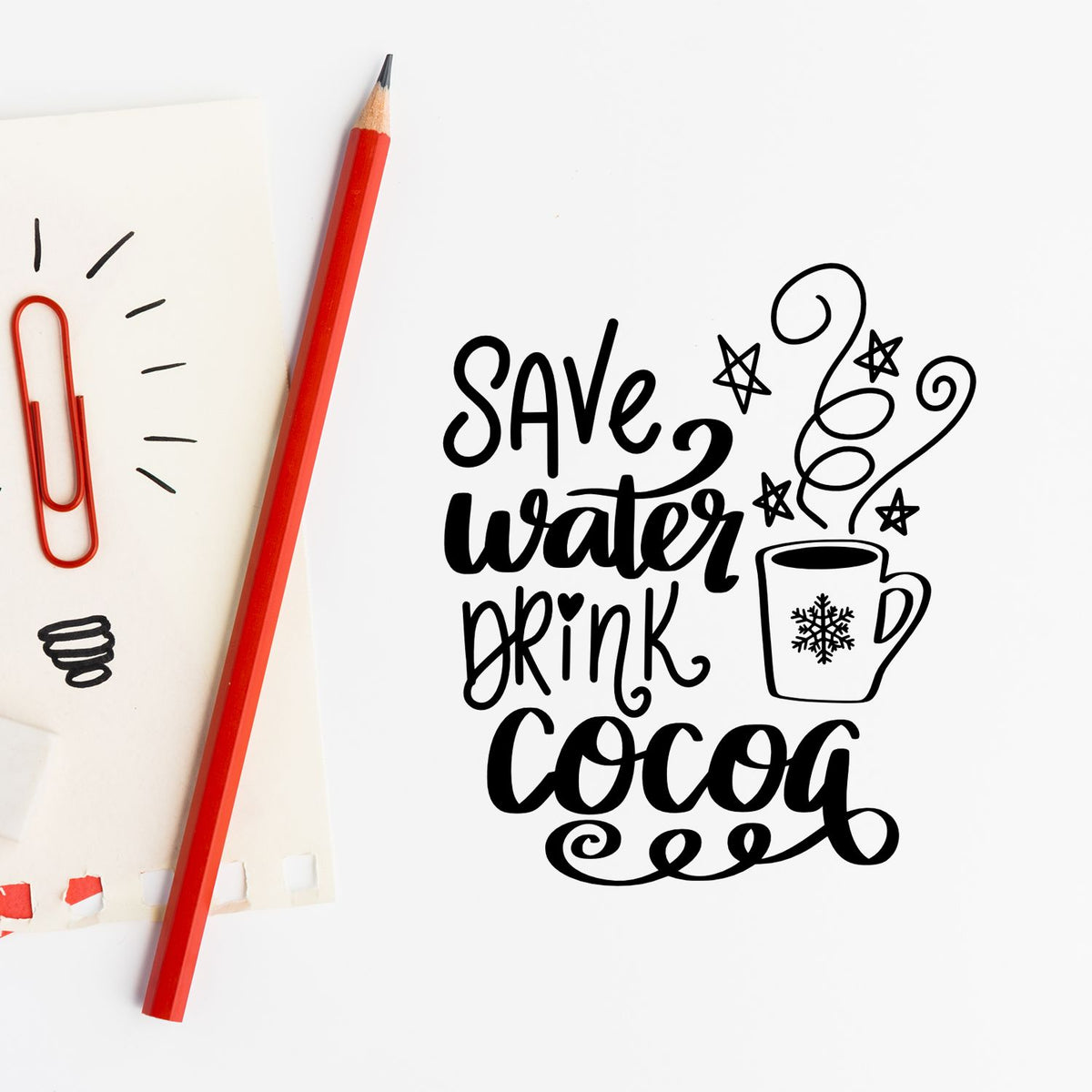 Black stamp design reading Save water drink cocoa with mug, stars, and swirls beside a red pencil and paper clip.