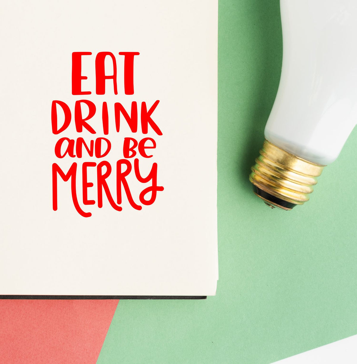 Red Eat Drink and Be Merry stamp and white-gold seal tool on green and white background.