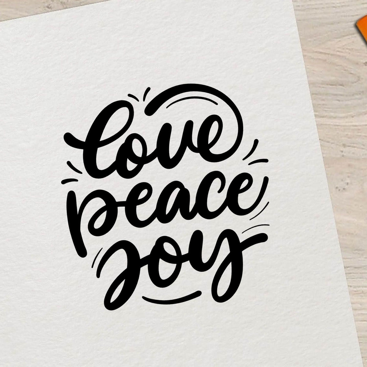 Black love peace joy script stamp seal in black on white paper, decorative stationery design.