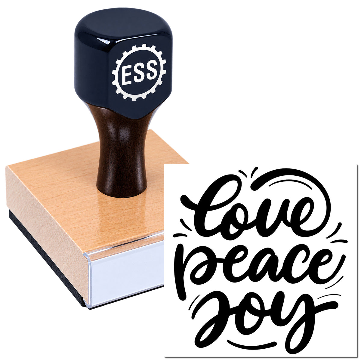Navy blue ESS seal stamp on a wooden block, printing a black "love peace joy" design
