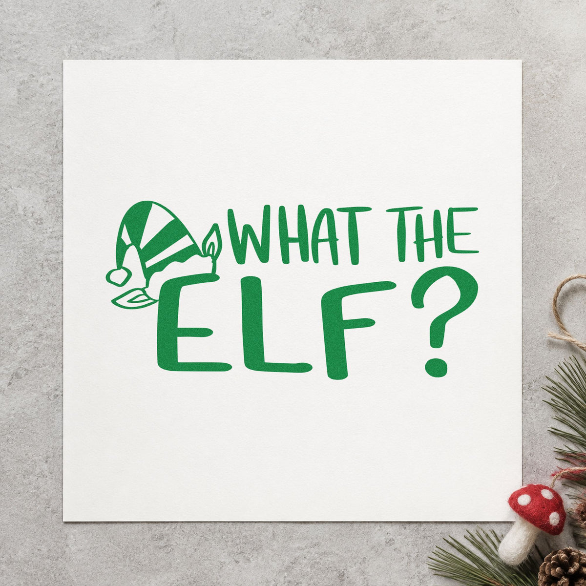 What The Elf craft stamp imprint in green ink on a handmade project, one idea being mischief log pages.