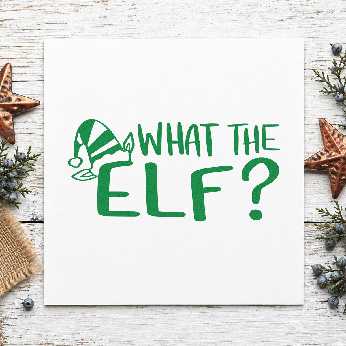 What The Elf craft stamp imprinted in green ink on paper, a design suited to prank bag seals.