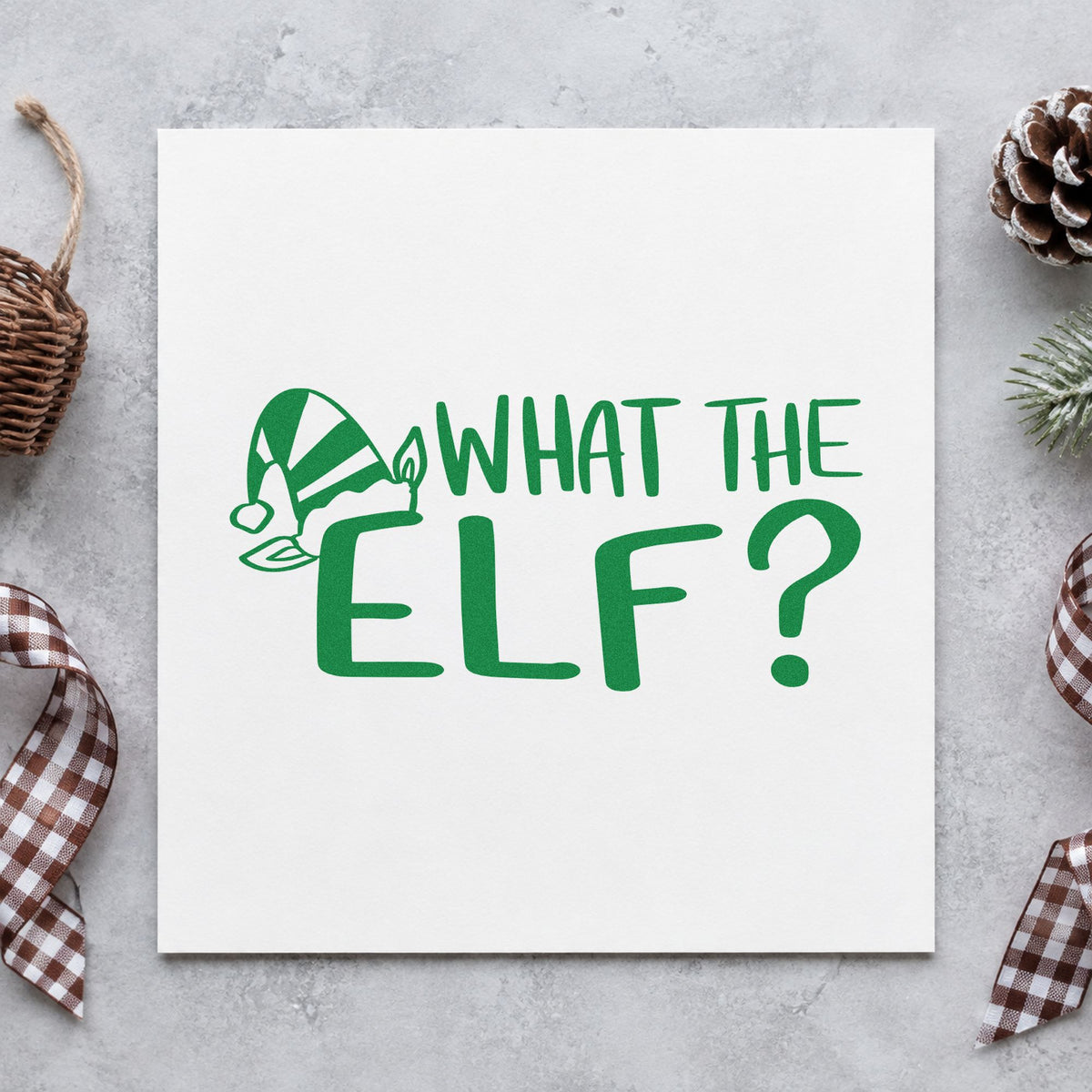 What The Elf craft stamp imprint in green ink on a handmade project, one idea being framed shelf spot.