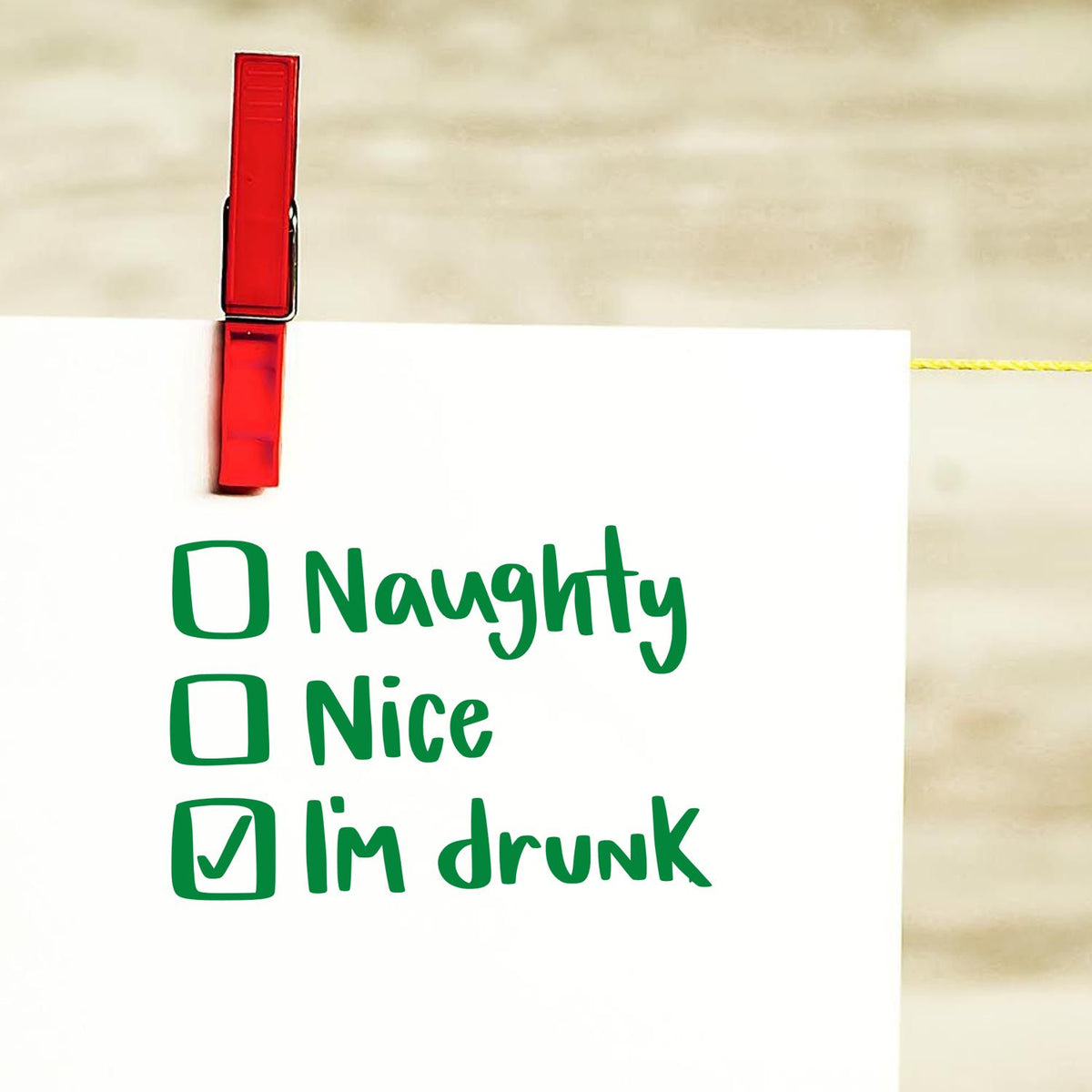 Red stamp-style clothespin seal on white note with green naughty, nice, and Im drunk checklist.