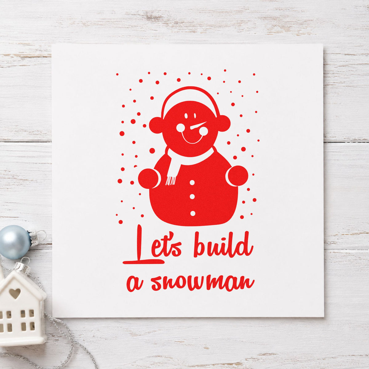 Let's Build A Snowman craft stamp in red ink on cardstock, an easy option for earmuff band panels.