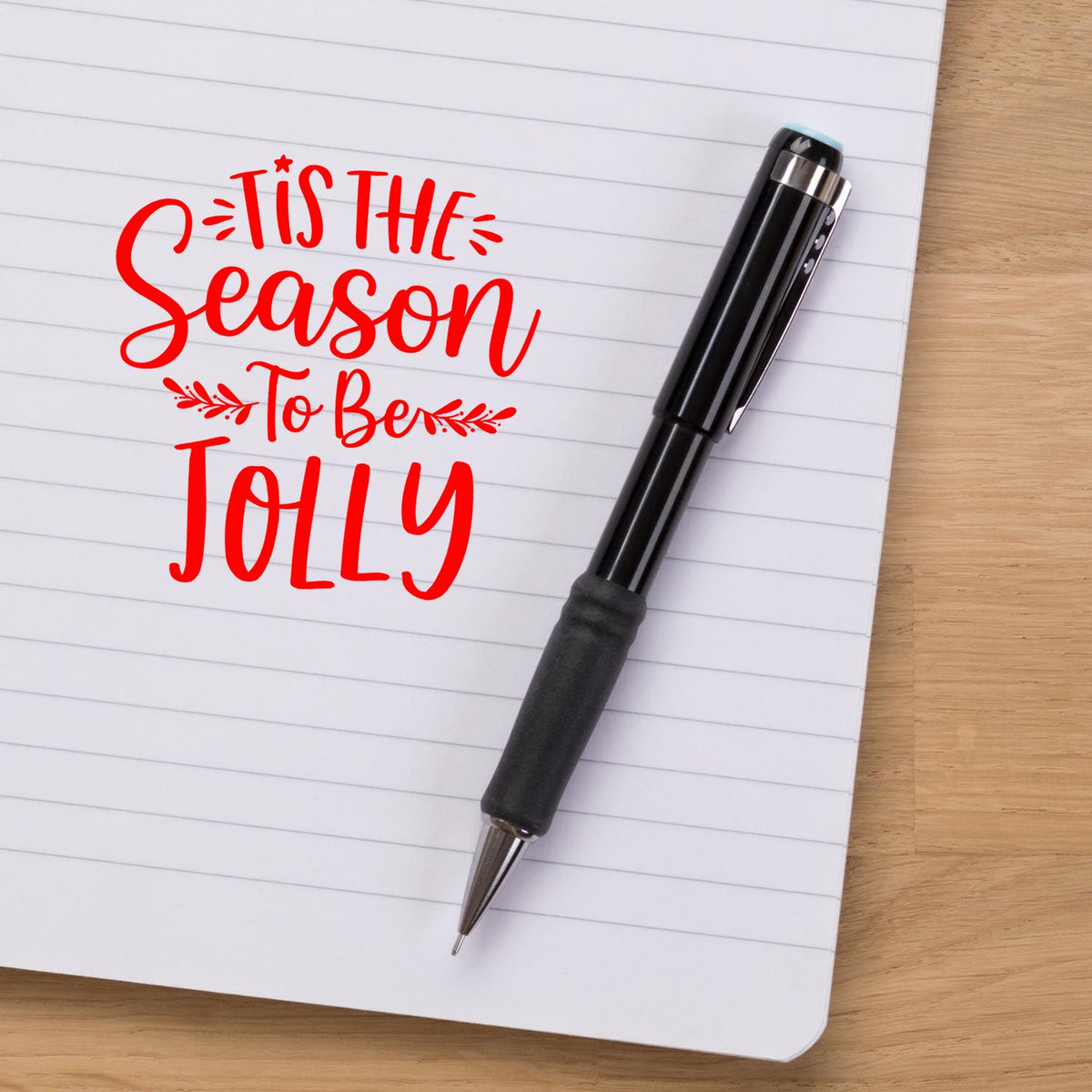 Black stamp and seal pen on lined notebook, with red Tis the Season to Be Jolly lettering.