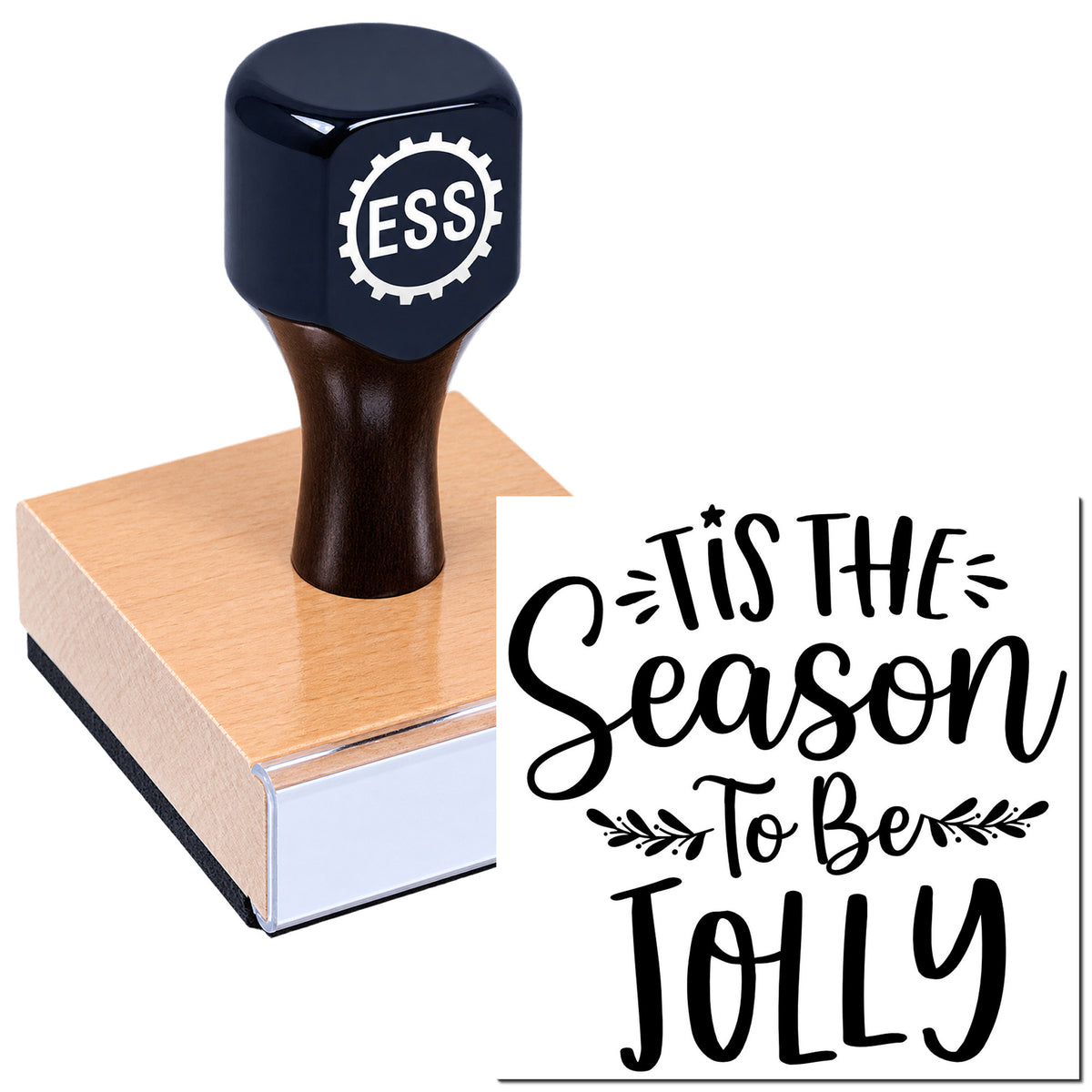 Black ESS stamp seal on a pink wooden block, with bold black "Tis the Season To Be Jolly" script design.