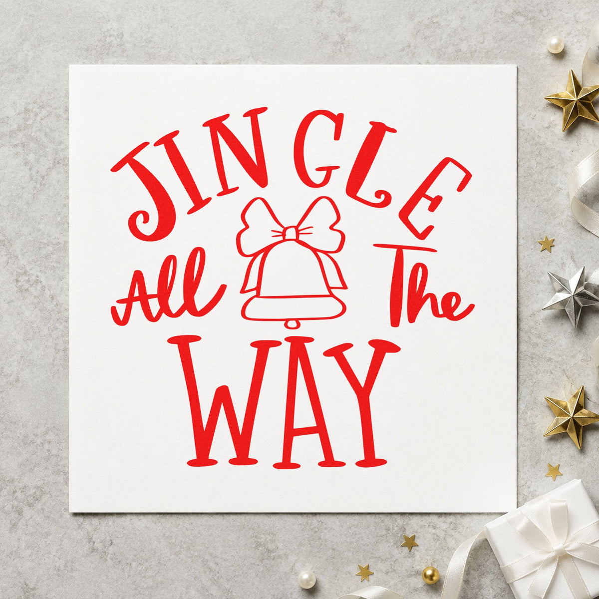 Jingle All The Way Bell craft stamp in red ink on cardstock, an easy option for ribbon sash printing.