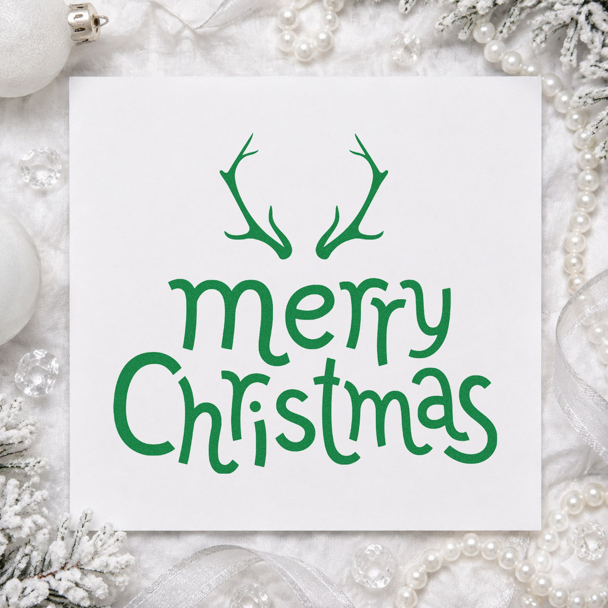 Merry Christmas Antlers craft stamp imprint in green ink on a handmade project, one idea being lodge dinner menus.