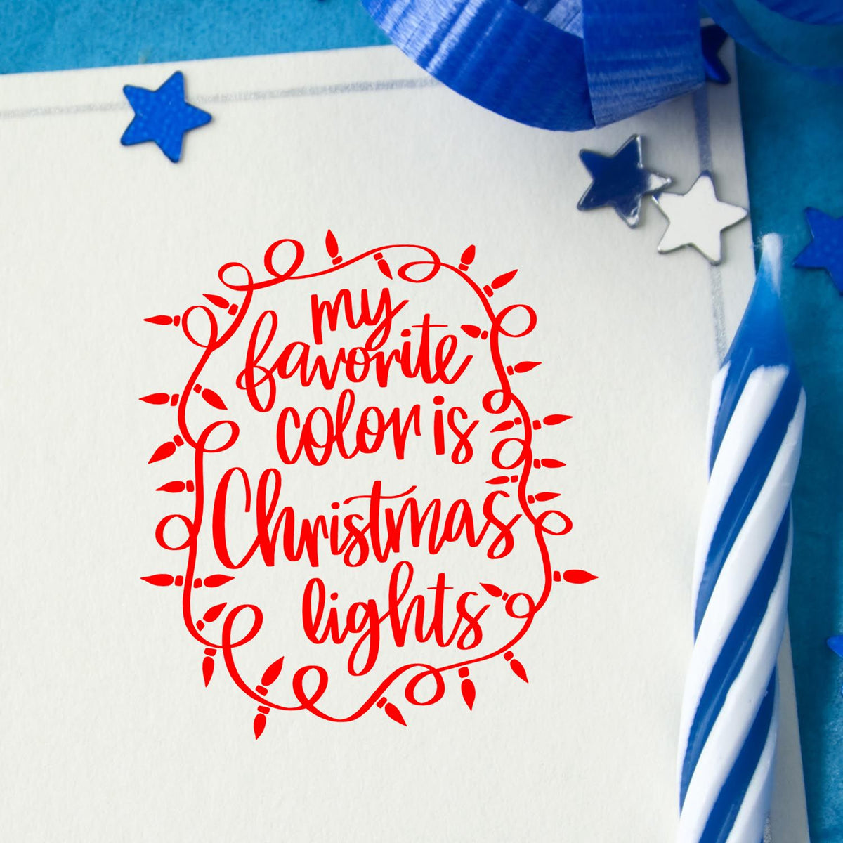Red Christmas light stamp reading my favorite color is Christmas lights on white card with blue stars and ribbon accents