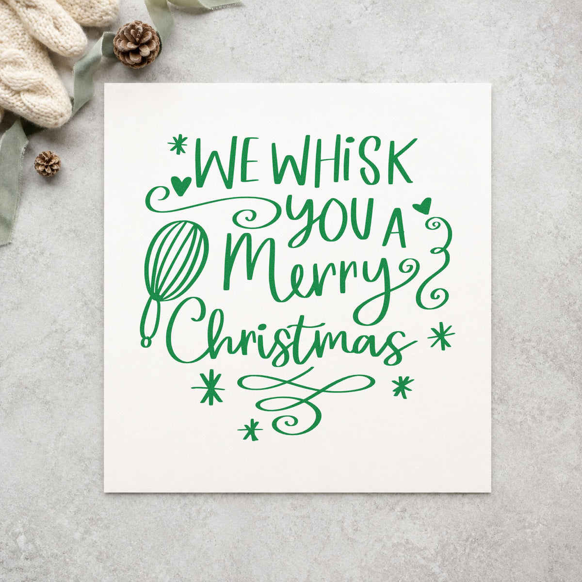 We Whisk Merry Christmas craft stamp imprint in green ink on a handmade project, one idea being bread loaf tags.