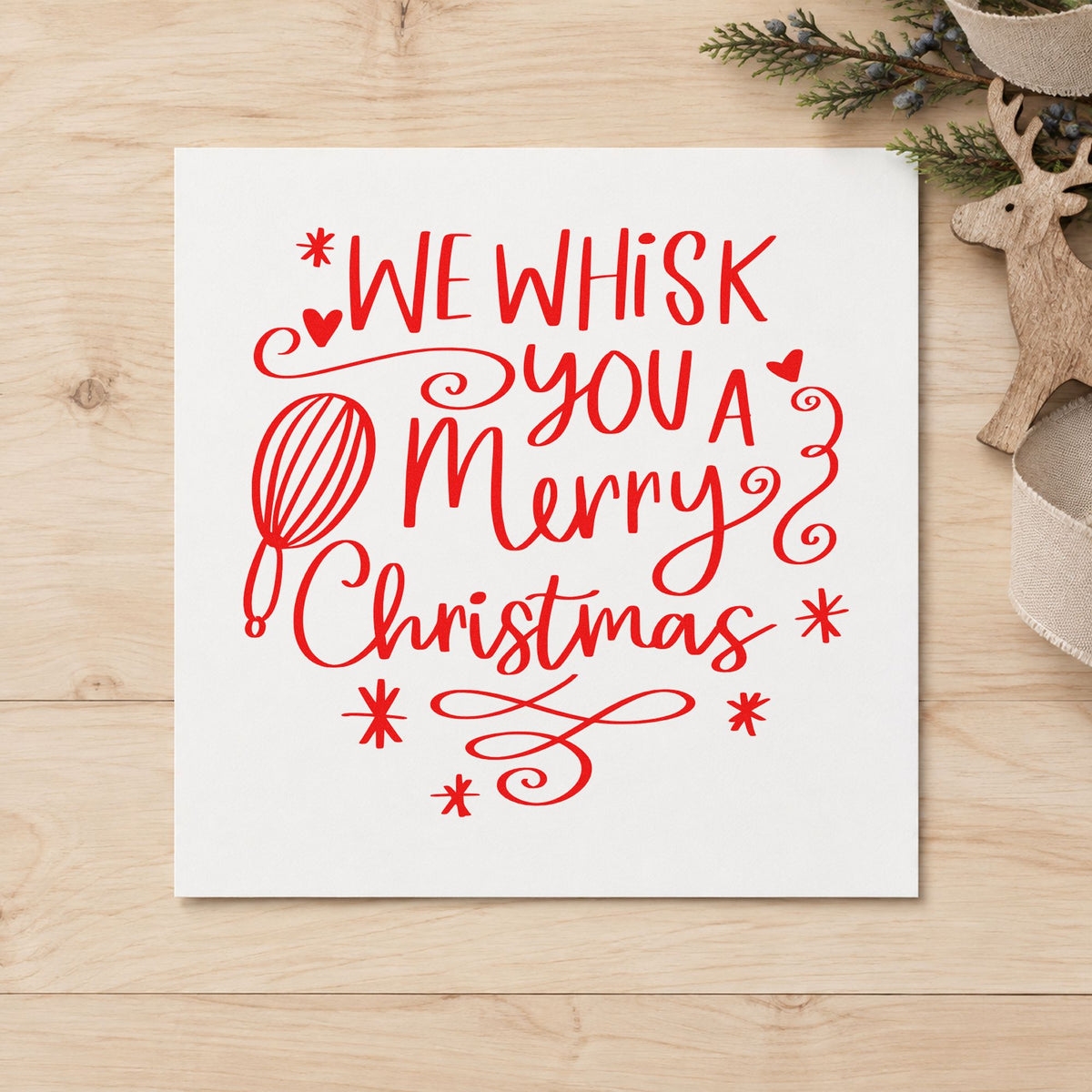 We Whisk Merry Christmas craft stamp in red ink on cardstock, an easy option for oven mitt printing.