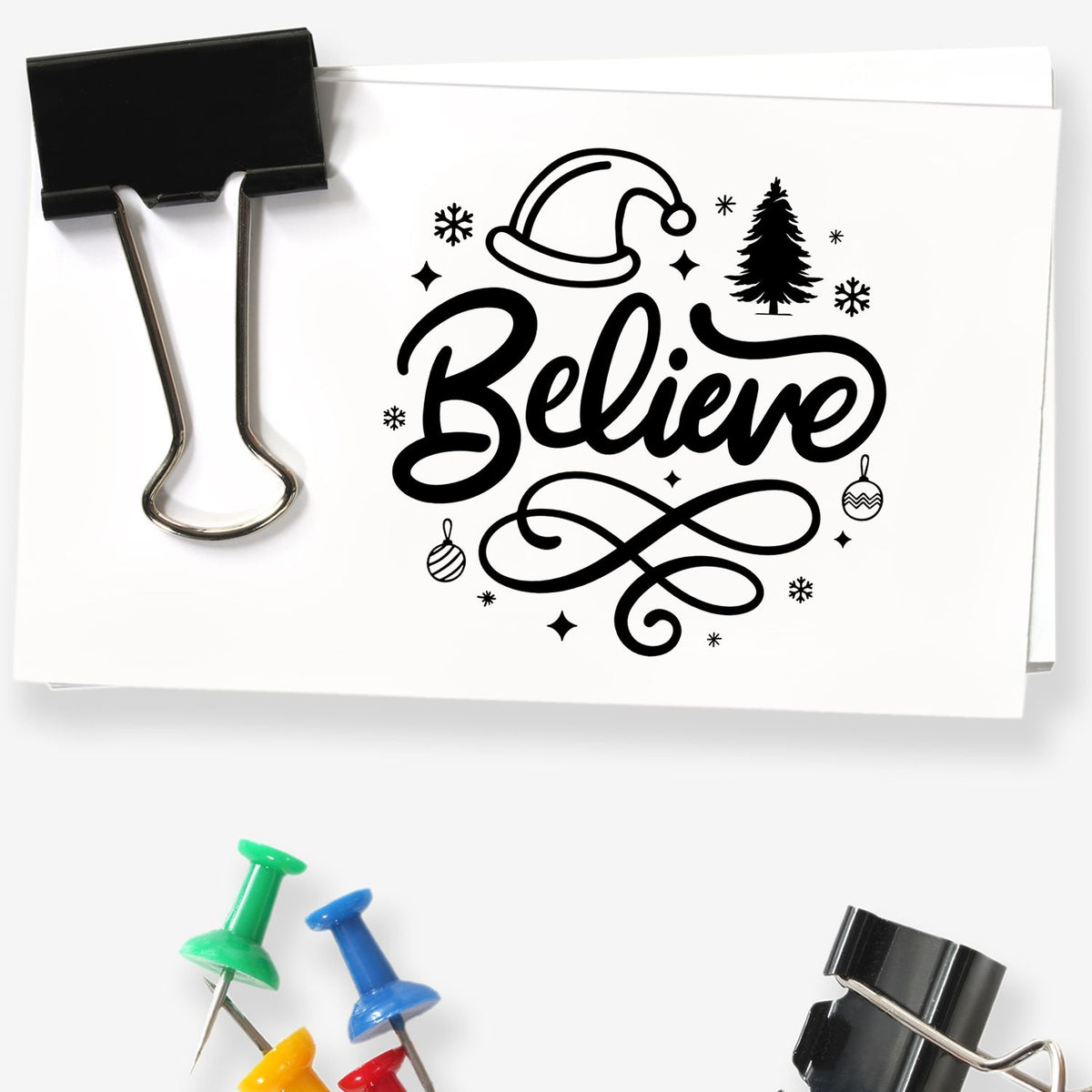 Black holiday stamp and seal design reading Believe with Santa hat, tree, snowflakes and ornaments on white paper.