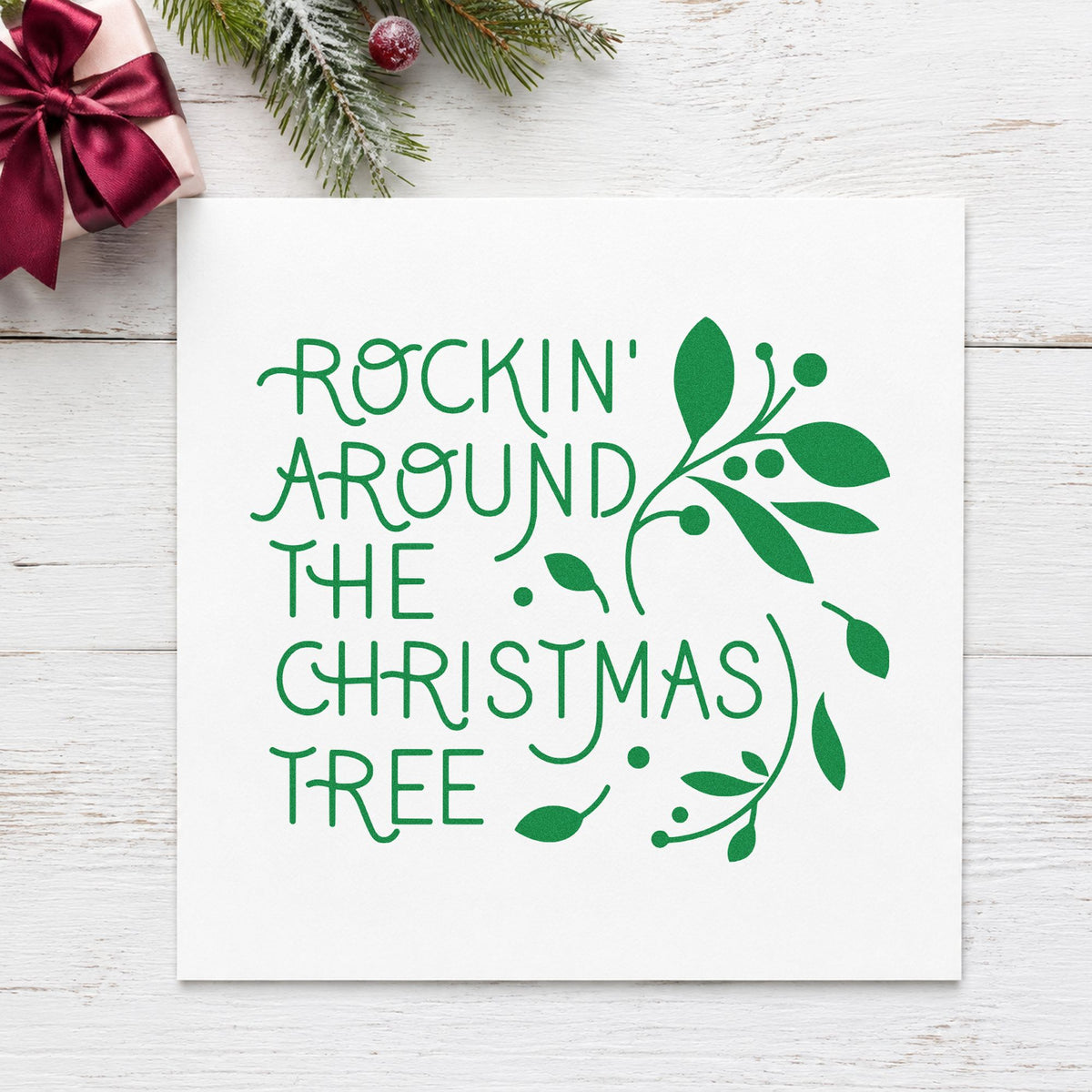 Rockin Around Christmas Tree craft stamp imprint in green ink on a handmade project, one idea being record sleeve tags.