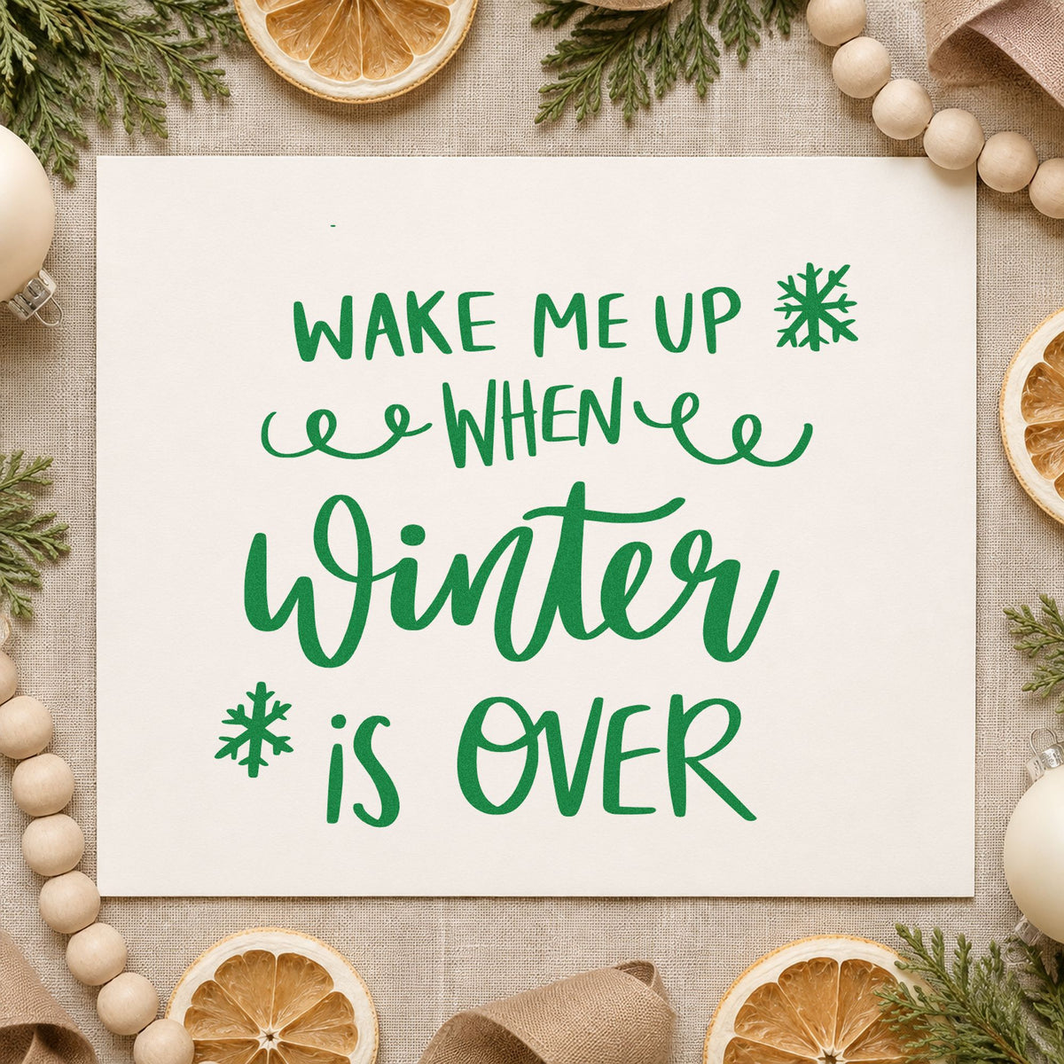 Wake Me When Winter Over craft stamp imprint in green ink on a handmade project, one idea being sleep mask gift tags.