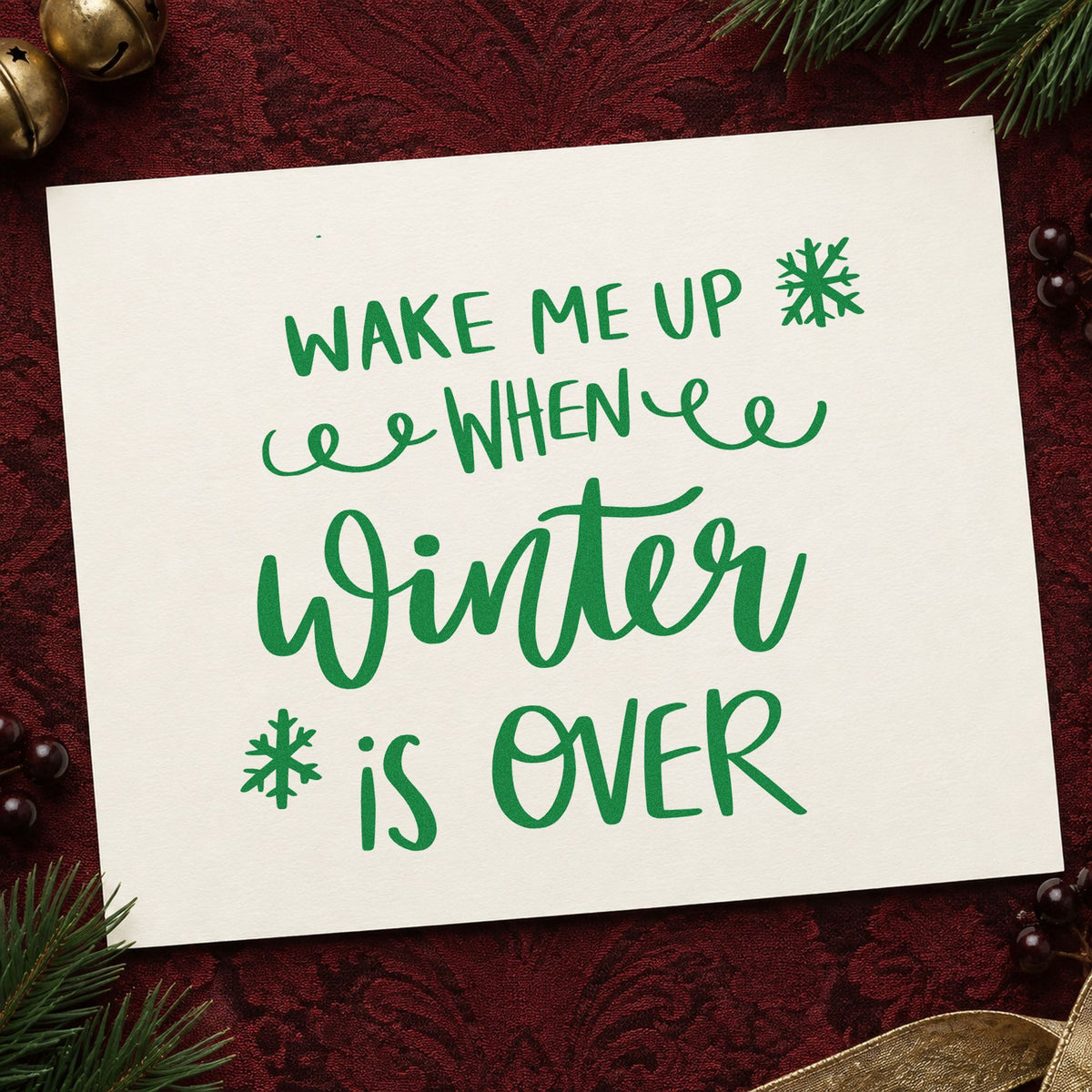 Wake Me When Winter Over craft stamp imprinted in green ink on paper, a design suited to framed bedroom door.