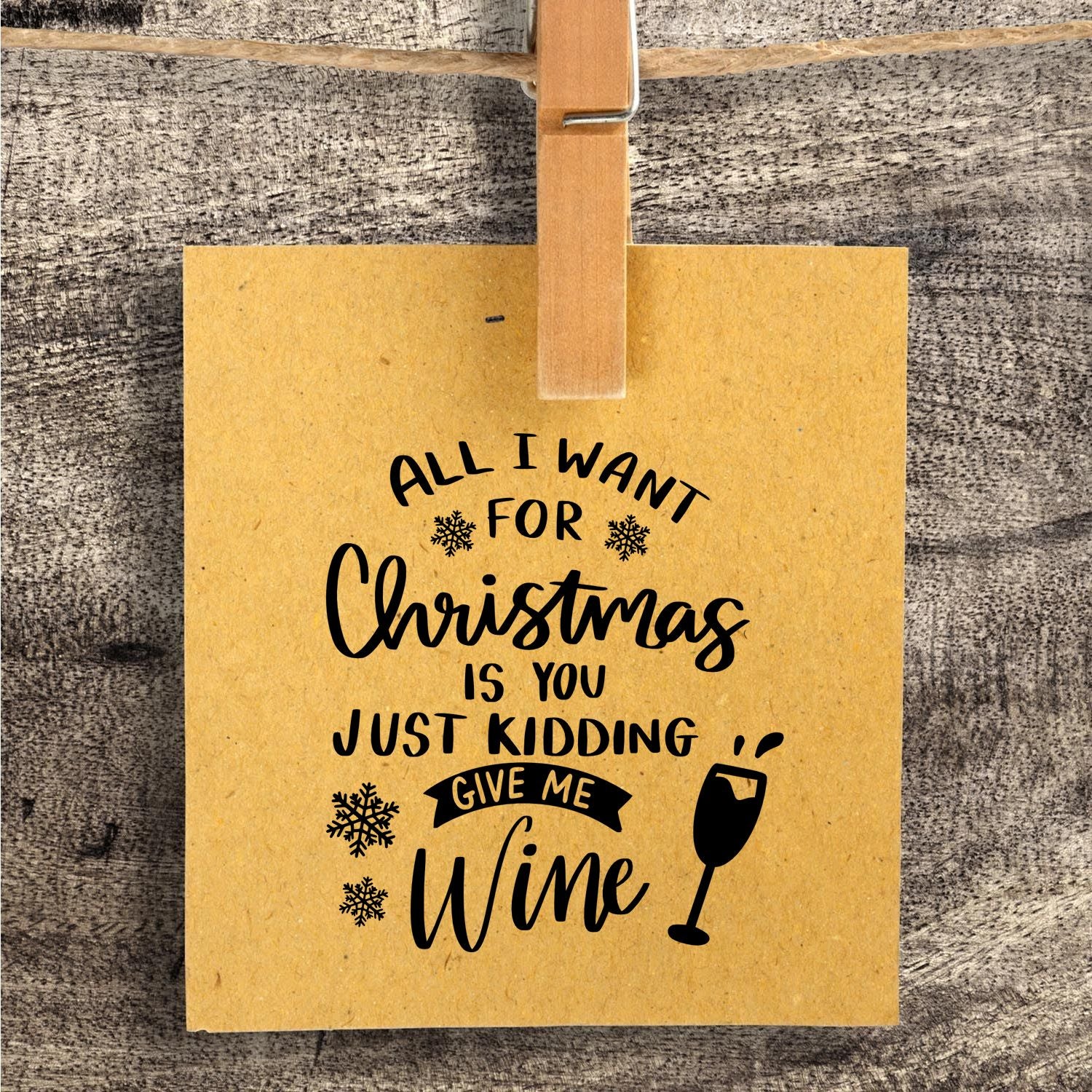 Custom stamp and seal on tan card with black Christmas sentiment, snowflakes and wine glass on rustic wood.