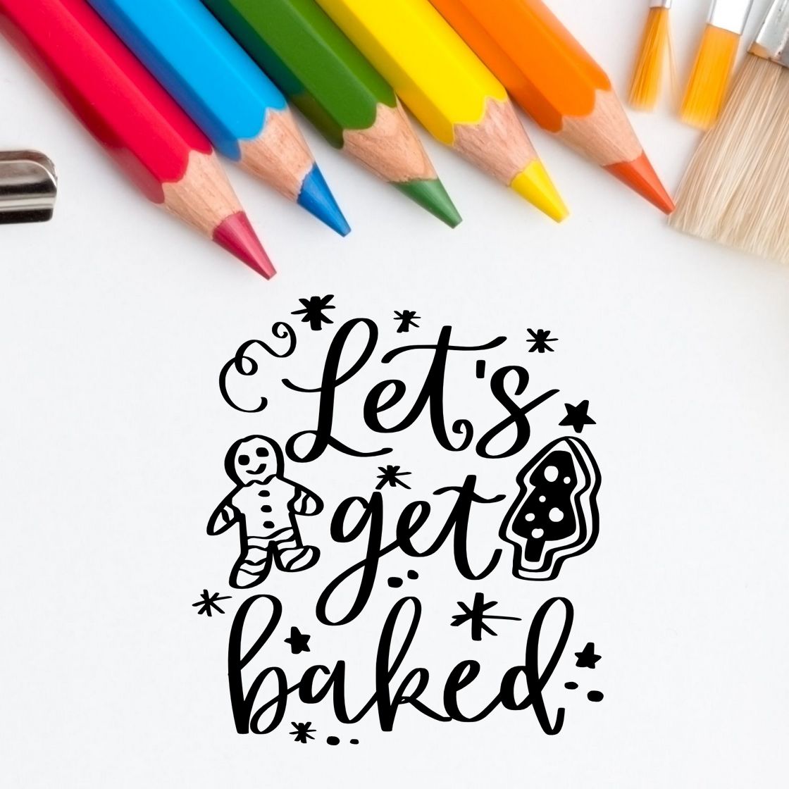 Black holiday stamp and seal design reading Lets get baked with gingerbread man, tree, stars; rainbow pencils above.