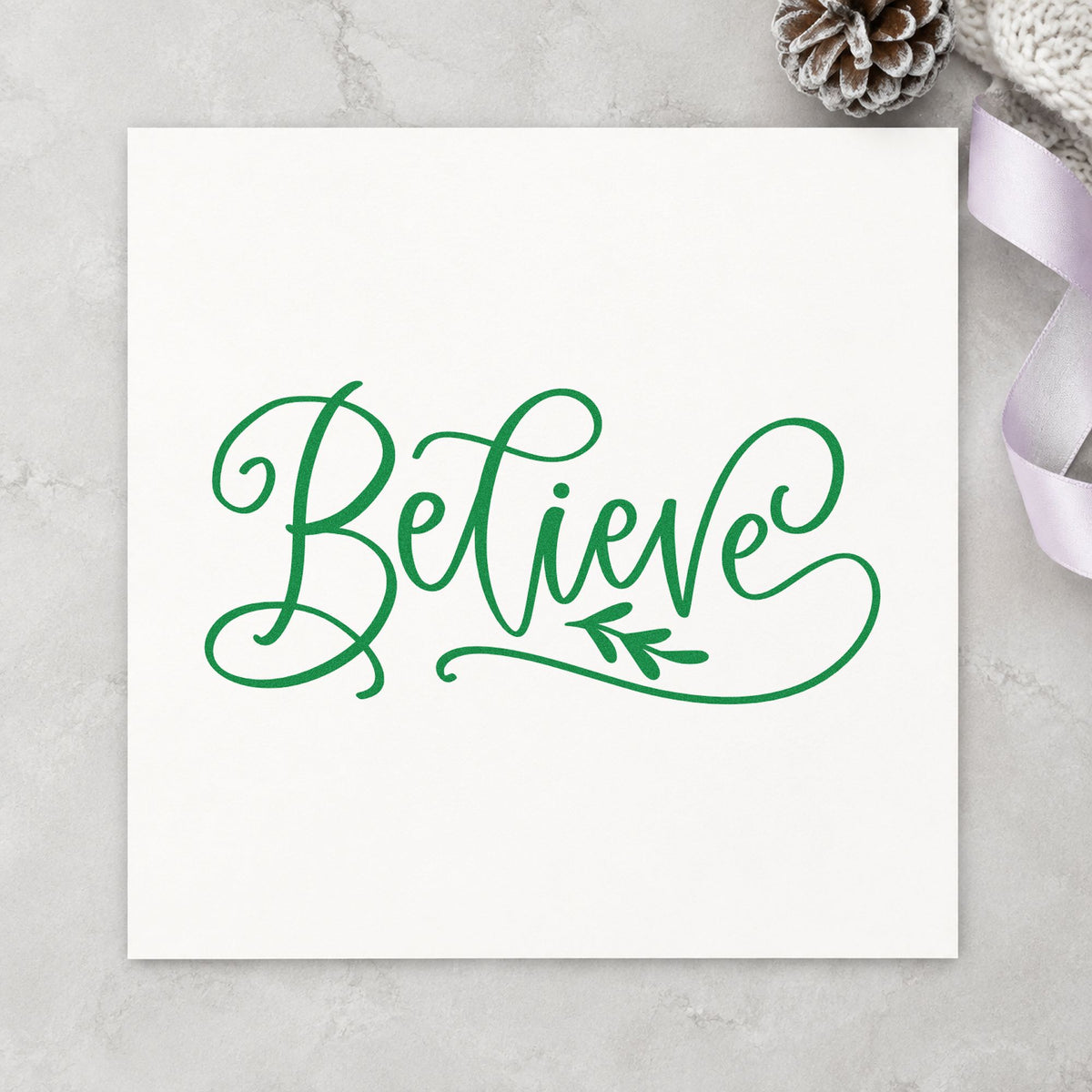 Believe With Leaf Flourish craft stamp imprint in green ink on a handmade project, one idea being reception table signs.